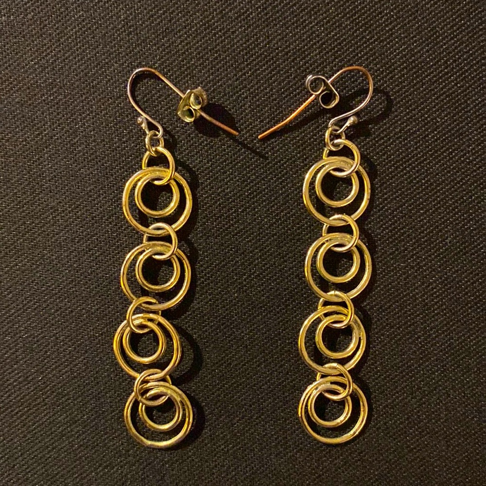 Gold dangle earrings.
